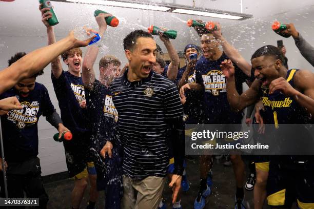 Head coach Shaka Smart of the Marquette Golden Eagles celebrates with players after winning the Big East regular season championship after a win over...