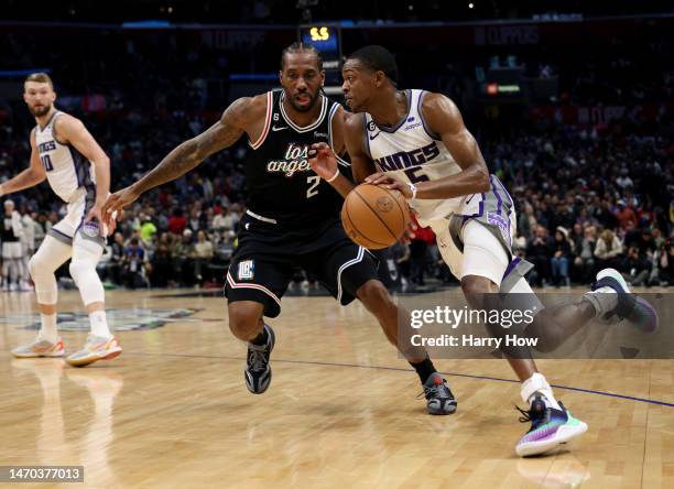 De'Aaron Fox of the Sacramento Kings drives to the basket on Kawhi Leonard of the LA Clippers during a 176-175 double overtime Kings win at...