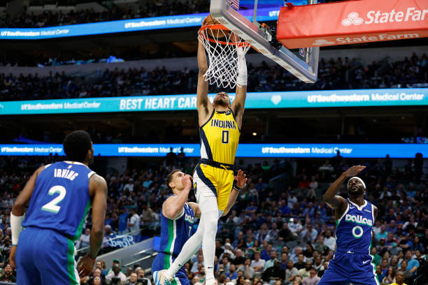 Tyrese Haliburton of the Indiana Pacers dunks the ball against Dwight Powell of the Dallas Mavericks in the first half at American Airlines Center on...
