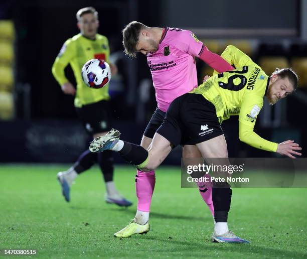 Sam Sherring of Northampton Town contests the ball with Luke Armstrong of Harrogate Town during the Sky Bet League Two between Harrogate Town and...