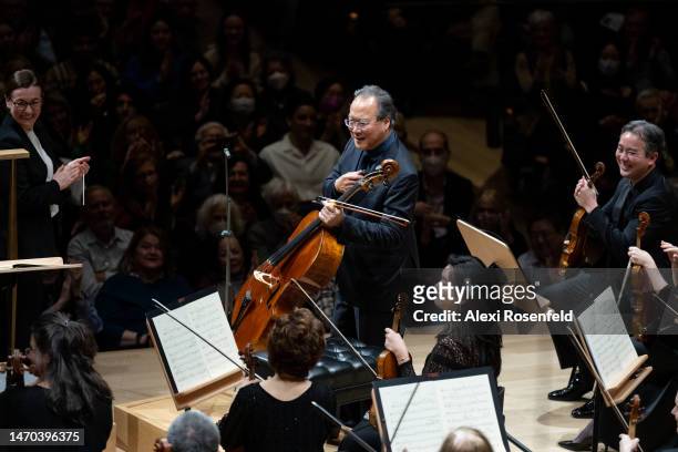 Conductor Daniela Candillari and concermaster Frank Huang watch as Yo-Yo Ma walks on stage at David Geffen Hall on February 28, 2023 in New York...