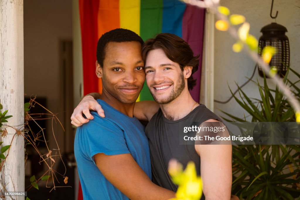 Portrait of gay couple with arms around each other