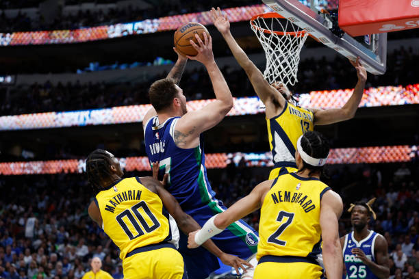 Luka Doncic of the Dallas Mavericks shoots against Bennedict Mathurin, Andrew Nembhard and Jordan Nwora of the Indiana Pacers in the second half at...