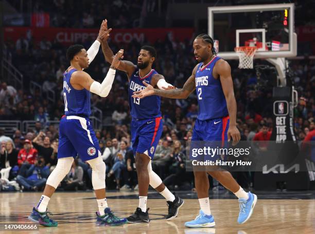 Kawhi Leonard, Paul George and Russell Westbrook of the LA Clippers celebrate after a timeout during the first half against the Minnesota...