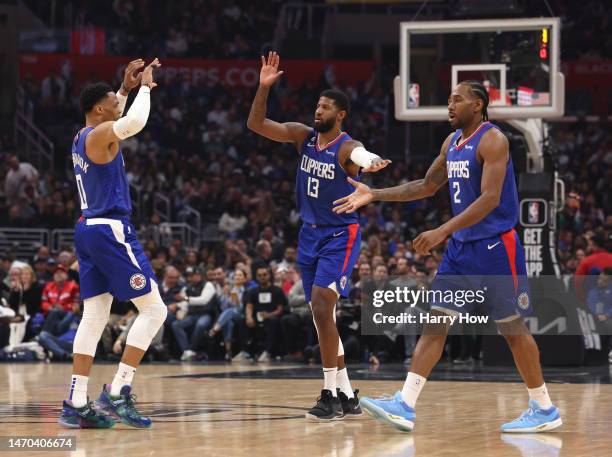 Kawhi Leonard, Paul George and Russell Westbrook of the LA Clippers celebrate after a timeout during the first half against the Minnesota...
