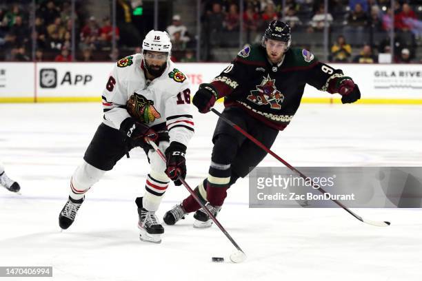 Jujhar Khaira of the Chicago Blackhawks skates with the puck against J.J. Moser of the Arizona Coyotes in the third period at Mullett Arena on...
