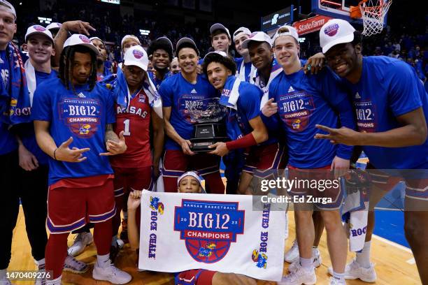 Members of the Kansas Jayhawks celebrate with the Big 12 conference trophy after their 67-63 win over Texas Tech Red Raiders at Allen Fieldhouse on...