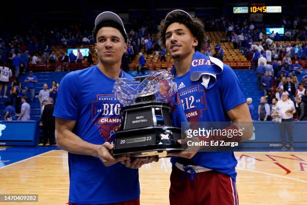 Jalen Wilson and Kevin McCullar Jr. #15 of the Kansas Jayhawks pose with the Big 12 conference trophy after their 67-63 win over Texas Tech Red...