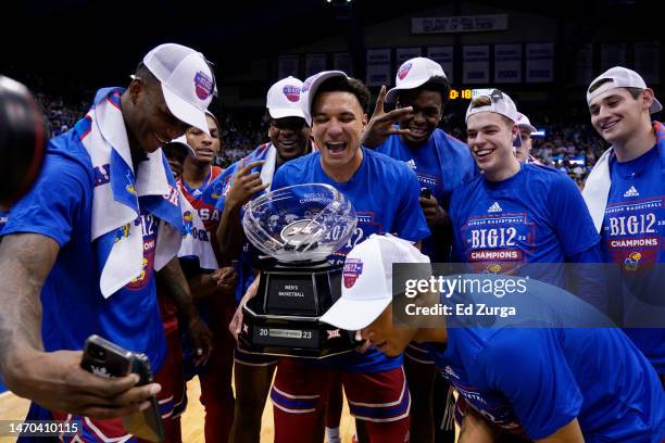 Members of the Kansas Jayhawks celebrate with the Big 12 conference trophy after their 67-63 win over Texas Tech Red Raiders at Allen Fieldhouse on...