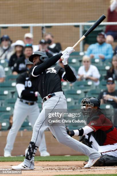 Luis Robert of the Chicago White Sox swings during the first inning against the Arizona Diamondbacks at Salt River Fields at Talking Stick on...