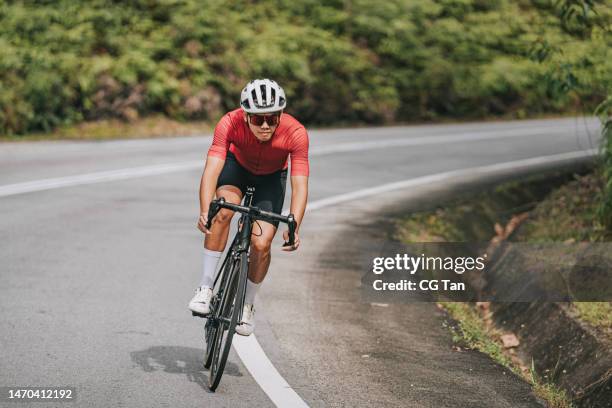 asian chinese professional cyclist athlete sportsman sprinting cycling in rural area - cyclist stock pictures, royalty-free photos & images