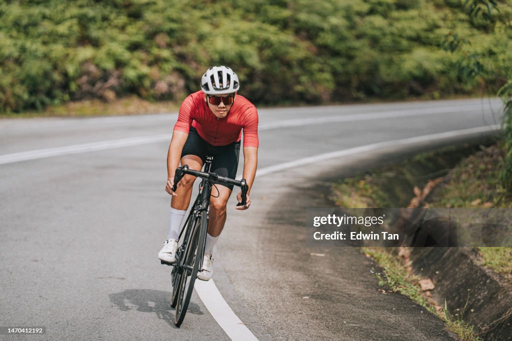 Asian Chinese professional cyclist athlete sportsman sprinting cycling in rural area