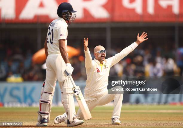 Nathan Lyon of Australia takes the wicket of KS Bharat of India during day one of the Third Test match in the series between India and Australia at...
