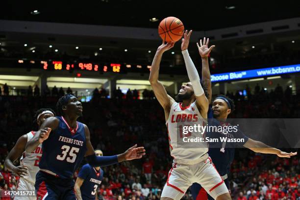 Jaelen House of the New Mexico Lobos shoots against Eduardo Andre and Jemarl Baker of the Fresno State Bulldogs during the second half of their game...