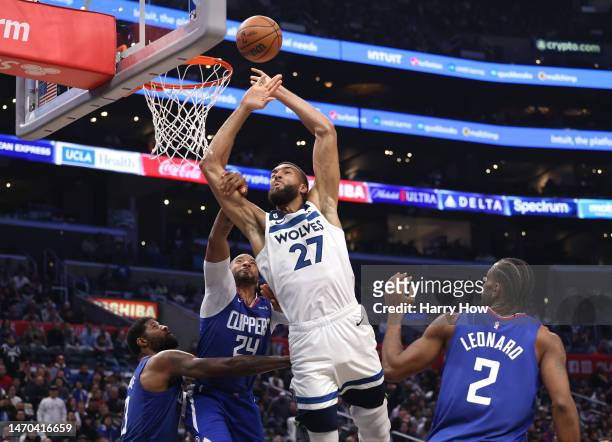 Rudy Gobert of the Minnesota Timberwolves reacts as he is fouled by Norman Powell of the LA Clippers as Paul George and Kawhi Leonard look on during...