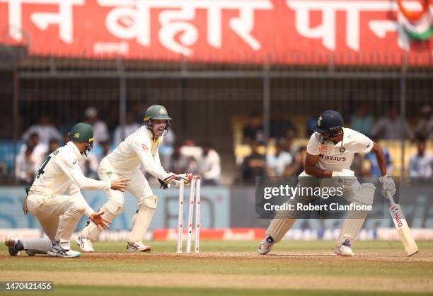 Ravichandran Ashwin of India is caught out by Alex Carey of Australia during day one of the Third Test match in the series between India and...