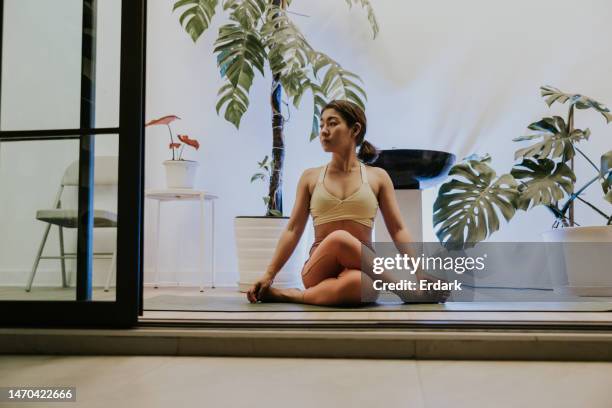 beautiful woman with her relaxing time, doing yoga at home. - hot yoga stock pictures, royalty-free photos & images