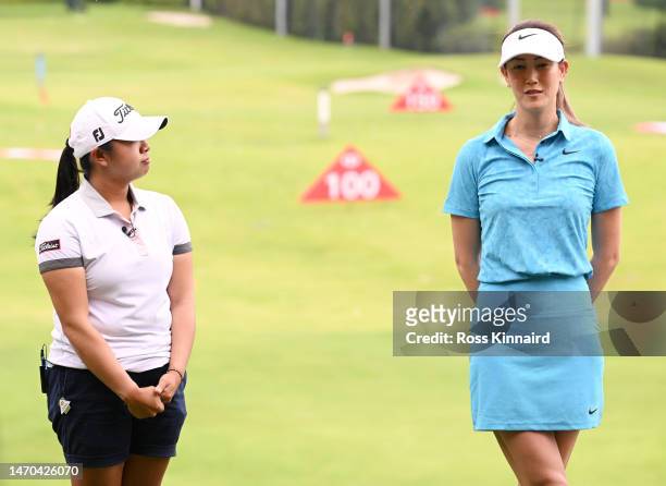 Amanda Tan of Singapore and Michelle Wie of The United States talk during a HSBC Sport junior clinic prior to the HSBC Women's World Championship at...