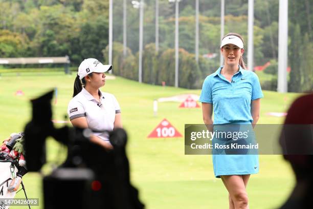 Amanda Tan of Singapore and Michelle Wie of The United States talk during a HSBC Sport junior clinic prior to the HSBC Women's World Championship at...