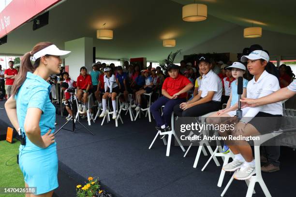 Michelle Wie of The United States talks with a junior during a HSBC Sport junior clinic prior to the HSBC Women's World Championship at Sentosa Golf...