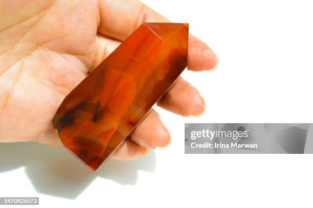 hand holding carnelian crystal tower - jasper mineral stock pictures, royalty-free photos & images