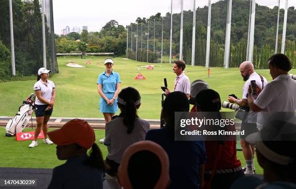 Amanda Tan of Singapore and Michelle Wie of The United States talk during a HSBC Sport junior clinic prior to the HSBC Women's World Championship at...