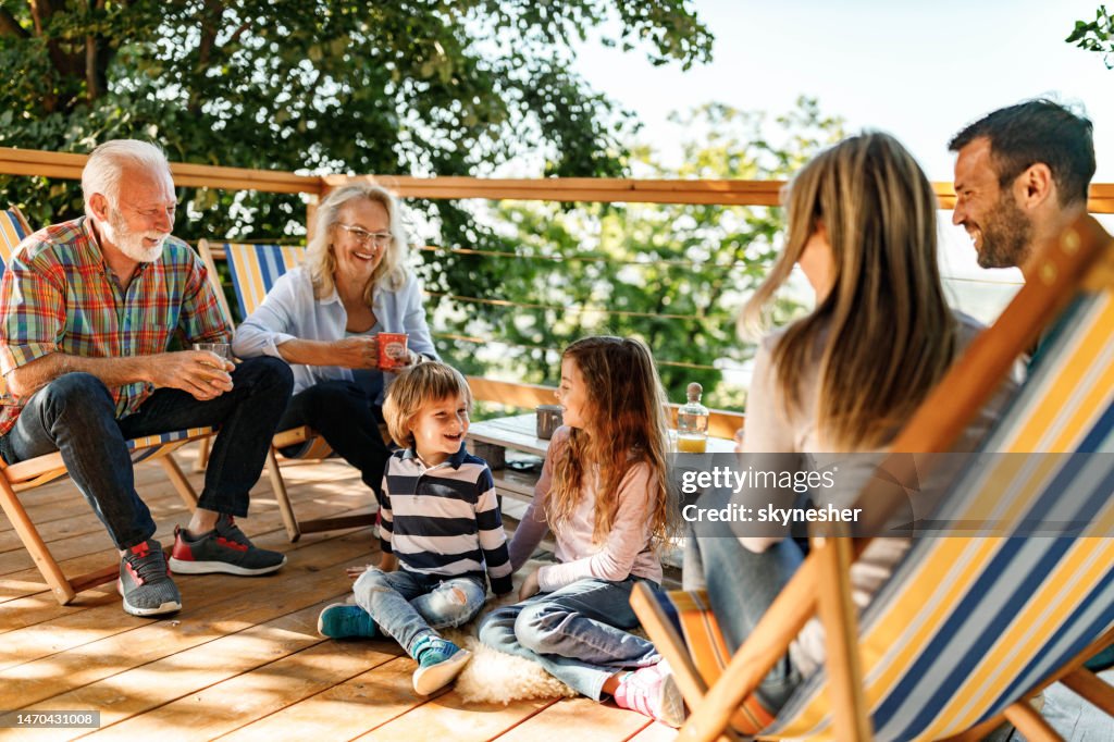 Happy extended family enjoying on a terrace.