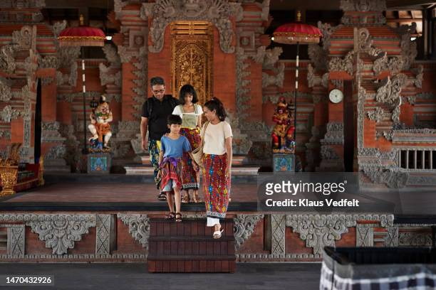 Family moving down on steps at temple