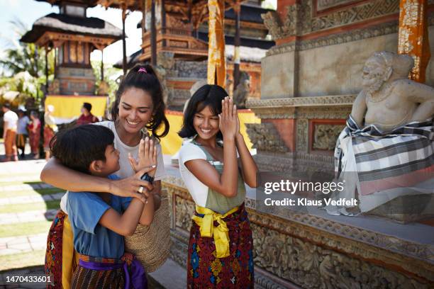 happy tourists enjoying at temple during vacation - showing respect bildbanksfoton och bilder