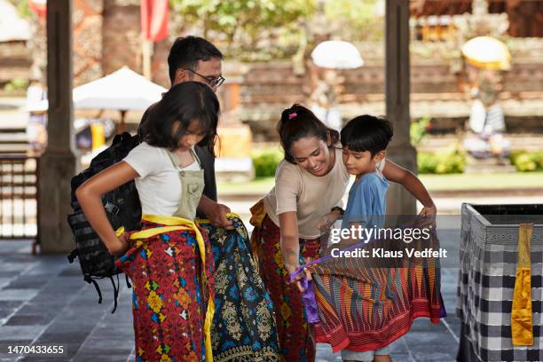 family wearing sarongs during vacation - 民族衣装 ストックフォトと画像