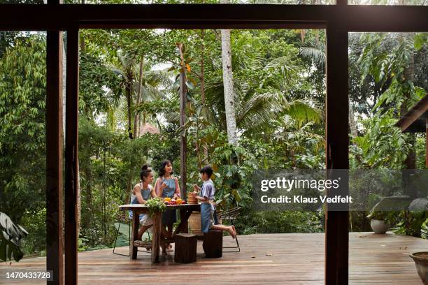 family preparing food at resort porch - southeast asia stock pictures, royalty-free photos & images