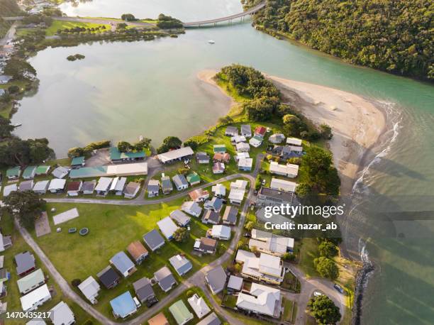 settlement next to beach. - new zealand beach house stock pictures, royalty-free photos & images