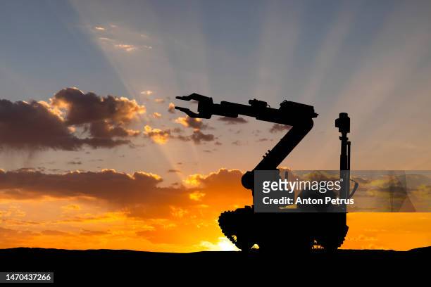 bomb disposal robot. robot sapper at sunset. - military intelligence stock pictures, royalty-free photos & images