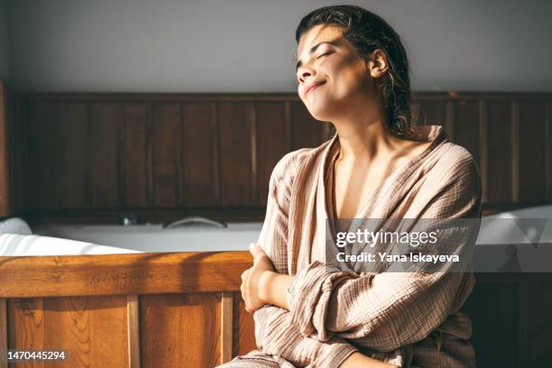 beautiful mediterranean woman relaxing in bathroom, taking time for herself - krama sig själv bildbanksfoton och bilder