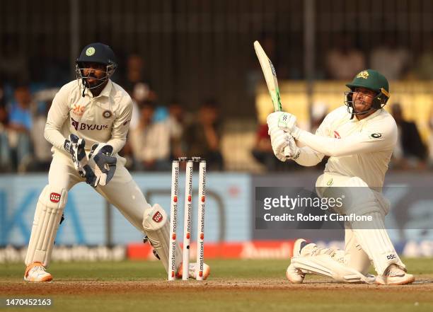 Usman Khawaja of Australia hits out during day one of the Third Test match in the series between India and Australia at Holkare Cricket Stadium on...
