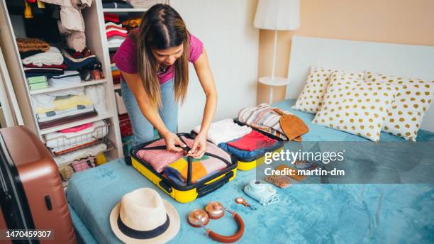 woman packing suitcase for travel - walking away from camera stock pictures, royalty-free photos & images