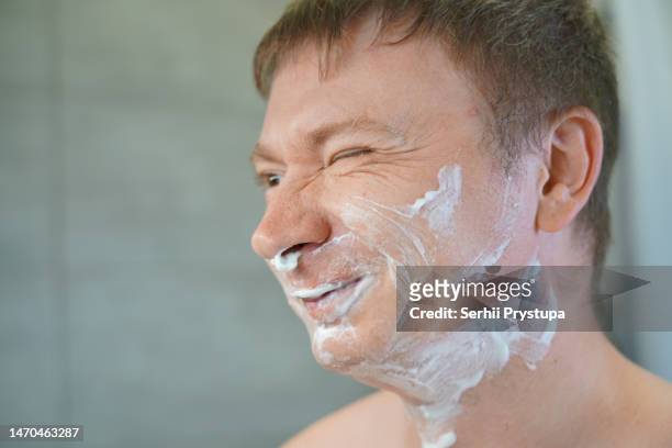 man holding a razor - shaving cream stock pictures, royalty-free photos & images
