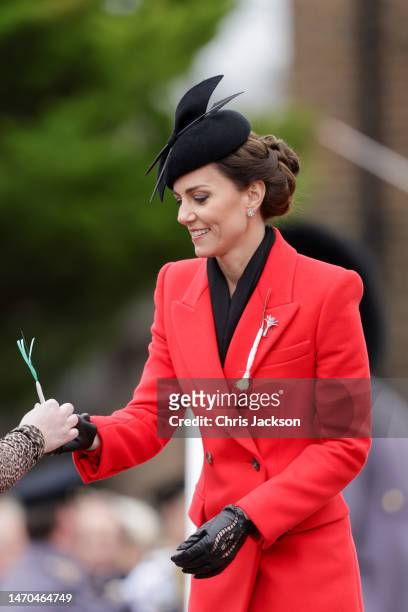 Catherine, Princess of Wales receives the traditional Leek from a member of the 1st Battalion Welsh Guards at Combermere Barracks during the St...
