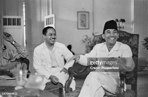 From left, state secretary Abdoel Gaffar Pringgodigdo looks on as Indonesian statesman Sukarno , recently appointed President of Indonesia, attends a...