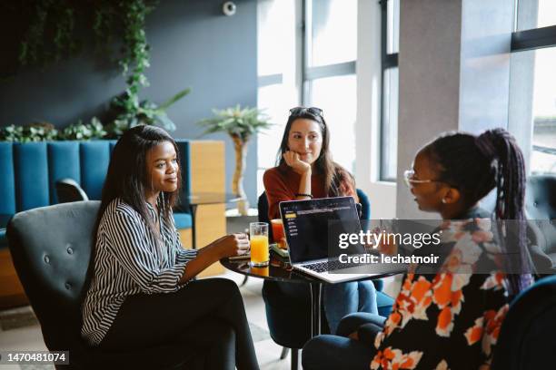 female colleagues discussing work - woman planning stock pictures, royalty-free photos & images