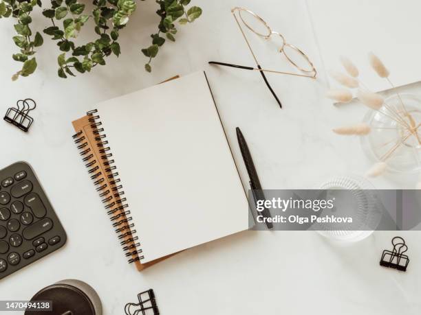 flat lay blank paper sheet in notebook, black keyboard, stationery on white background. - office work flat lay stock pictures, royalty-free photos & images