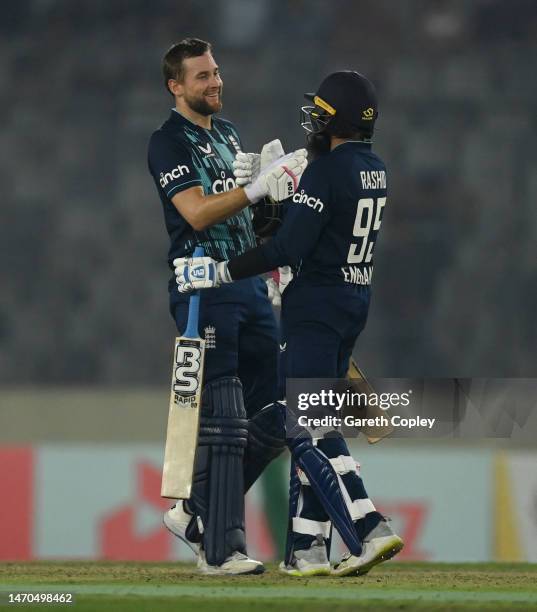 Dawid Malan of England celebrates with Adil Rashid after reaching his century during the 1st One Day International between Bangladesh and England at...