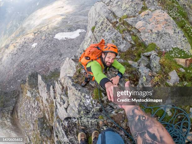 pov of two mountaineers reaching peak - extreme sports point of view stock pictures, royalty-free photos & images