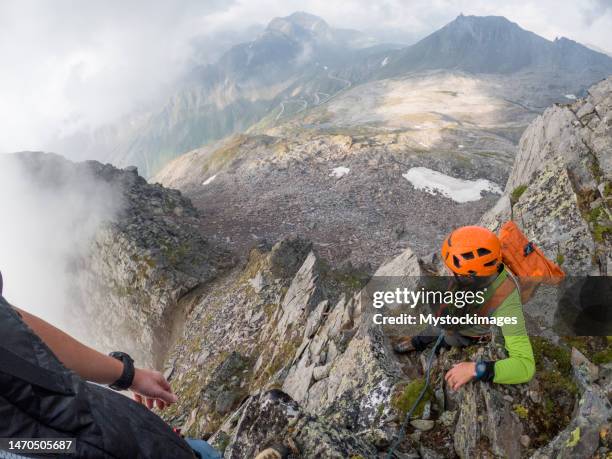 pov of two mountaineers reaching peak - extreme sports point of view stock pictures, royalty-free photos & images