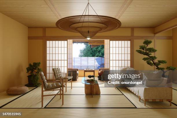 japanese style living room interior with sofa, armchair, coffee table and potted plant - hanging lamp stock pictures, royalty-free photos & images