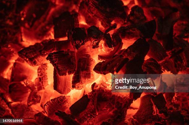 full frame shot of burning coals in the stove. - wood burning stove stock-fotos und bilder