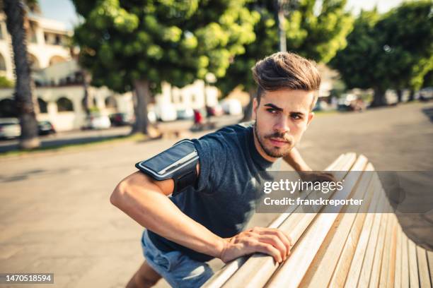 man doing stretching in the city - south africa v italy stock pictures, royalty-free photos & images