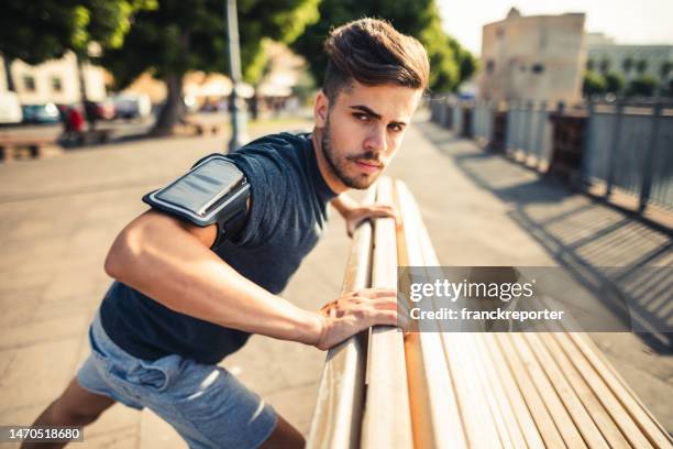 man doing stretching in the city - south africa v italy stock pictures, royalty-free photos & images