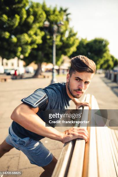 man doing stretching in the city - south africa v italy stock pictures, royalty-free photos & images