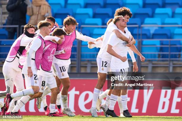 Iker Bravo of Real Madrid celebrates with teammates after scoring the team's third goal during the UEFA Youth League Round of Sixteen match between...